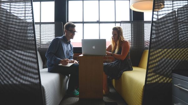 Two people looking at a computer screen