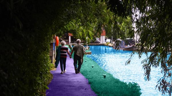 Elderly couple walking by the river